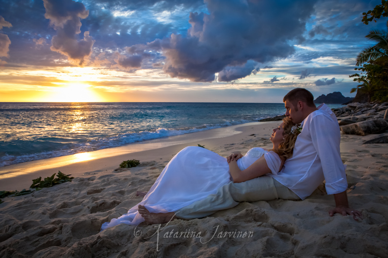 wedding couple lying on beach at sunset